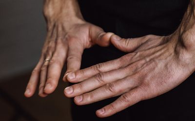 Close-up of hands in a meditative gesture, calm and still.