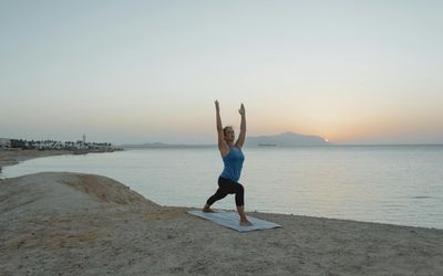 Person holding a strong warrior yoga pose, showing balance and power.